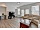 Spacious living room with wood floors, large windows, and an entertainment center at 2212 Whistler Ne Way, Lawrenceville, GA 30043