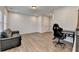 Living room area with a couch, desk, and modern chair on wood floors at 2212 Whistler Ne Way, Lawrenceville, GA 30043