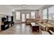 Open living room with a large sectional sofa, wood floors, and lots of natural light at 2212 Whistler Ne Way, Lawrenceville, GA 30043