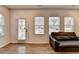 Open-concept living room with ample windows, wood floors and a comfortable couch at 2212 Whistler Ne Way, Lawrenceville, GA 30043