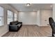 Bright living space features wood floors, two windows, natural light and recessed lighting at 2212 Whistler Ne Way, Lawrenceville, GA 30043