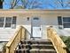 Front porch with wooden steps, white siding, and gray shutters at 2495 Se Glendale Se Cir, Smyrna, GA 30080