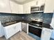 Kitchen features white cabinets, dark countertop and stainless steel appliances at 2495 Se Glendale Se Cir, Smyrna, GA 30080