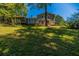 A spacious backyard featuring a well-maintained lawn and mature trees, offering ample space for outdoor activities and relaxation at 4230 Deerwood Se Pkwy, Smyrna, GA 30082