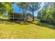 Well-maintained backyard featuring a screened-in porch and mature landscaping at 4230 Deerwood Se Pkwy, Smyrna, GA 30082