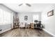 Bright room showcasing wood floors, ceiling fan, ladder shelf, desk, and chair at 4230 Deerwood Se Pkwy, Smyrna, GA 30082