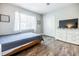 Bedroom with TV, closet, light grey walls, and updated flooring at 4230 Deerwood Se Pkwy, Smyrna, GA 30082