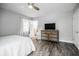 Comfortable bedroom featuring wood floors, ceiling fan, and ensuite bathroom at 4230 Deerwood Se Pkwy, Smyrna, GA 30082