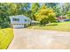 Two-story home with a large driveway, attached garage, and a well-maintained front yard at 4230 Deerwood Se Pkwy, Smyrna, GA 30082