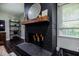 Living room fireplace with dark painted brick and decorative mantle at 4230 Deerwood Se Pkwy, Smyrna, GA 30082