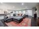 Spacious living room featuring a large sectional, seamless flow to kitchen and hardwood floors at 4230 Deerwood Se Pkwy, Smyrna, GA 30082