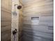 Stylish walk-in shower with stone pebble accents and recessed shower caddy at 4230 Deerwood Se Pkwy, Smyrna, GA 30082
