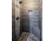 Updated shower boasts pebble flooring and tiled walls with convenient niche at 4230 Deerwood Se Pkwy, Smyrna, GA 30082