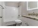 Bathroom with vanity and granite countertop, white tiled shower and floors at 1340 Bernard Nw St, Atlanta, GA 30314