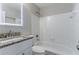 Clean bathroom featuring white tiled walls, a granite countertop, and an illuminated mirror at 1340 Bernard Nw St, Atlanta, GA 30314