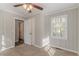 A bedroom with plush carpet, paneled walls, a ceiling fan and a window at 1340 Bernard Nw St, Atlanta, GA 30314