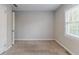 Empty bedroom showcasing carpeted floors, neutral walls, and a bright window at 1340 Bernard Nw St, Atlanta, GA 30314