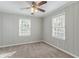 Light-filled bedroom featuring wood paneling, plush carpet, and a ceiling fan at 1340 Bernard Nw St, Atlanta, GA 30314