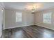 Spacious living room with gray walls, modern light fixture, and luxury vinyl plank flooring at 1340 Bernard Nw St, Atlanta, GA 30314