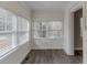 Bright sunroom featuring large windows offering lots of natural light and stylish gray flooring at 1340 Bernard Nw St, Atlanta, GA 30314