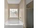 Bathroom featuring a bathtub, shower, and a window for natural lighting at 835 N Bay Overlook, Villa Rica, GA 30180