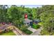 An aerial shot showcasing a charming two-story home with a long driveway, surrounded by lush greenery at 921 Cone Rd, Forest Park, GA 30297