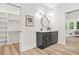 A modern double vanity bathroom with updated fixtures and a closet with built-in shelving at 921 Cone Rd, Forest Park, GA 30297
