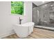 Contemporary bathroom with a freestanding tub, glass shower, and views of the outdoors at 921 Cone Rd, Forest Park, GA 30297