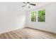 Bright bedroom with neutral walls, light wood flooring, ceiling fan and views of lush greenery outside at 921 Cone Rd, Forest Park, GA 30297