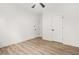 Bedroom with neutral walls, light wood flooring, ceiling fan and multiple paneled interior doors at 921 Cone Rd, Forest Park, GA 30297