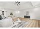 Bright bedroom boasts wood floors, a tray ceiling with fan, and a sliding barn door at 921 Cone Rd, Forest Park, GA 30297