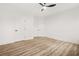 Spacious bedroom with wood floors, ceiling fan, and three doors leading to other rooms at 921 Cone Rd, Forest Park, GA 30297