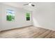 Bright bedroom with wood flooring, white walls, and natural light from the lush greenery outside at 921 Cone Rd, Forest Park, GA 30297