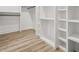 Spacious walk-in closet with wood floors and white custom shelving perfect for organization at 921 Cone Rd, Forest Park, GA 30297