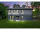 Charming two-story home featuring a well-manicured lawn and lush landscaping around the property at 921 Cone Rd, Forest Park, GA 30297