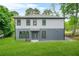 Beautiful two-story home featuring fresh landscaping, a manicured lawn, and two-tone siding at 921 Cone Rd, Forest Park, GA 30297