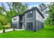 Attractive home with modern architecture, a private balcony, an attached garage and verdant lawn at 921 Cone Rd, Forest Park, GA 30297