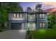 Beautiful two-story home featuring modern design, gray and white color scheme, and an attached garage at 921 Cone Rd, Forest Park, GA 30297