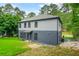 Well-maintained two-story home with mature trees and landscaping, and ample parking at 921 Cone Rd, Forest Park, GA 30297