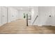 Spacious hallway with multiple doors and a staircase leading to the next level, all with modern wood floors at 921 Cone Rd, Forest Park, GA 30297