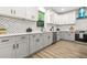 Well-lit kitchen with quartz countertops, gray and white cabinets, and stainless steel appliances at 921 Cone Rd, Forest Park, GA 30297