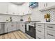 Updated kitchen featuring stainless steel appliances, gray cabinets, and backsplash at 921 Cone Rd, Forest Park, GA 30297