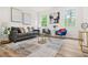 Cozy living room featuring comfortable seating, stylish decor, and natural light from the windows at 921 Cone Rd, Forest Park, GA 30297