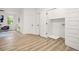 Bright living room features light wood floors and a laundry room with modern doors and trim at 921 Cone Rd, Forest Park, GA 30297