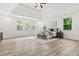 Bright main bedroom with a trey ceiling, fan, and natural light streaming through multiple windows at 921 Cone Rd, Forest Park, GA 30297