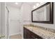 Bathroom featuring granite countertops, modern fixtures, and a shower with glass doors at 2116 N Forest Trl, Dunwoody, GA 30338