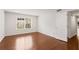 Spacious bedroom with hardwood floors, large window, and a door to additional space at 2116 N Forest Trl, Dunwoody, GA 30338