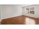Bright bedroom with hardwood floors, large window, and a clean, modern aesthetic at 2116 N Forest Trl, Dunwoody, GA 30338