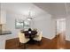 Bright dining room with hardwood floors, modern lighting, and seating for four at 2116 N Forest Trl, Dunwoody, GA 30338