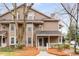 Two-story townhome with neutral siding and a cozy covered entrance, surrounded by mature trees and landscaping at 2116 N Forest Trl, Dunwoody, GA 30338